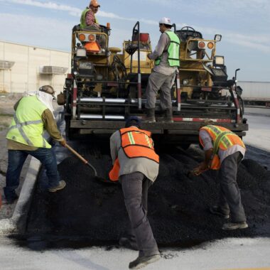 Men Putting Asphalt on the Road